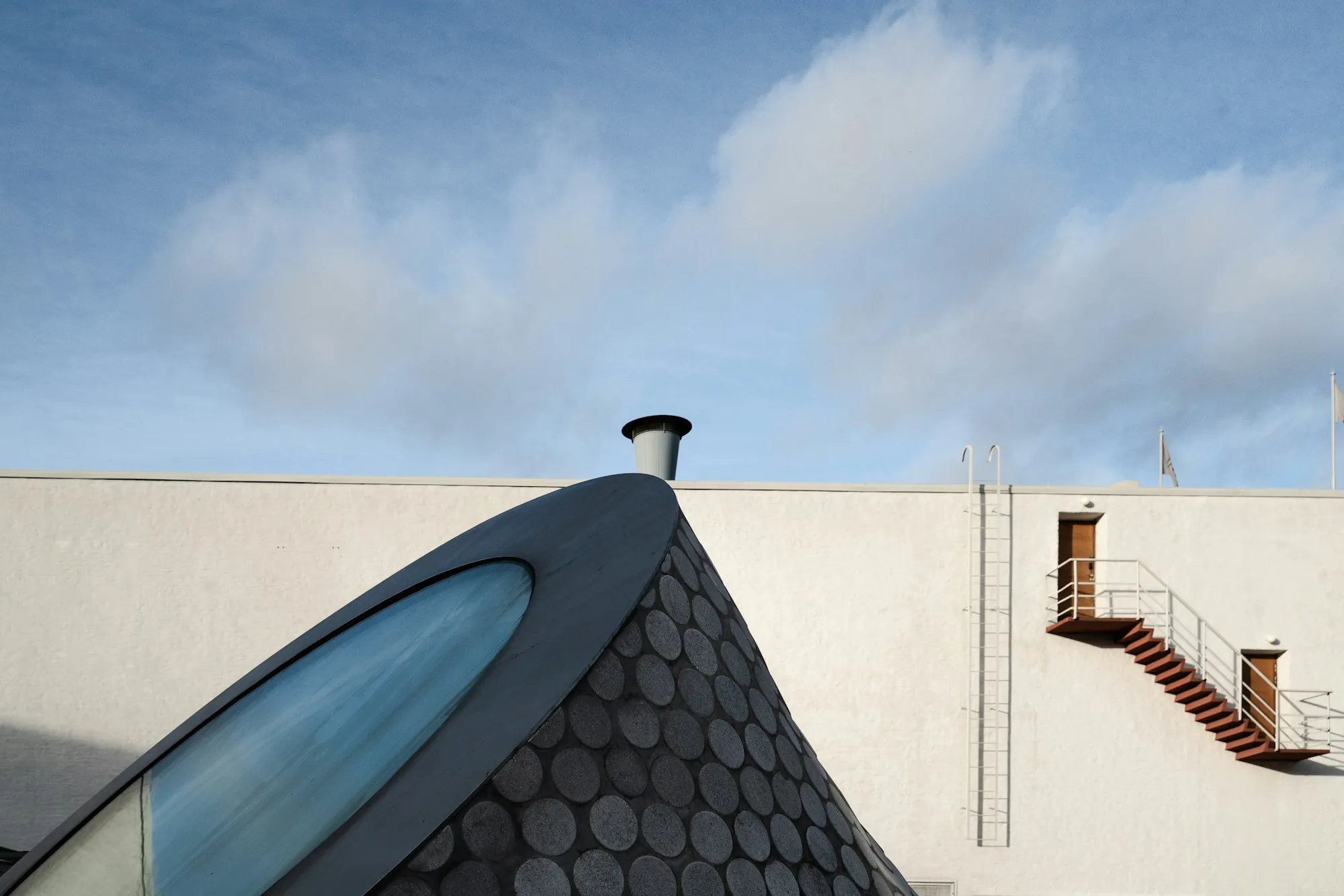 Curved roof covered in round scalloped shingles